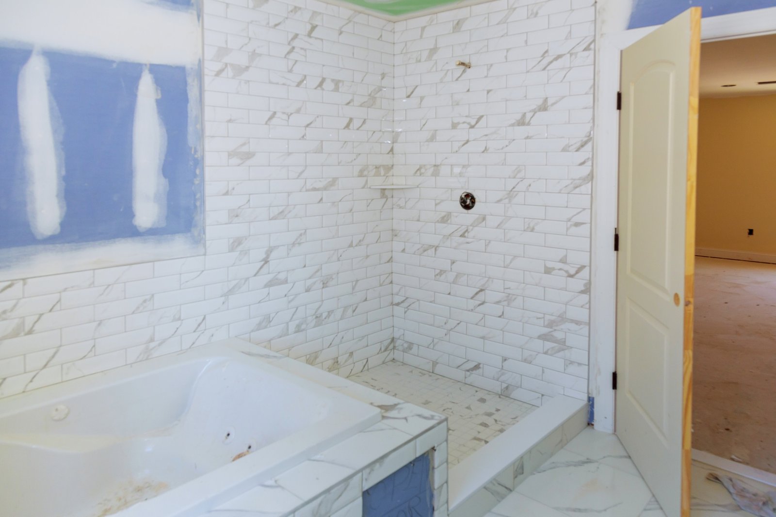 Drywall is hung in remodeling bathroom interior with drywall and patching